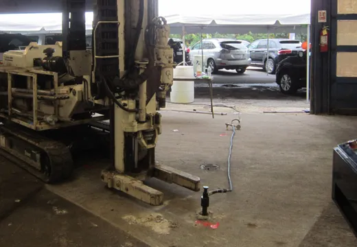 GCE track-mounted geoprobe drilling rig staged inside a garage bay